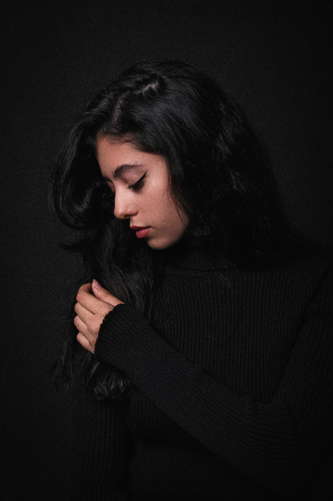 Studio portrait of a woman with long dark hair