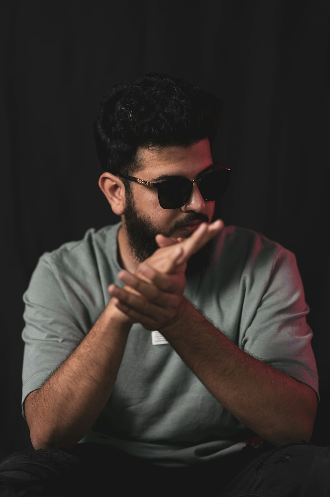 Studio portrait of a bearded man with glasses